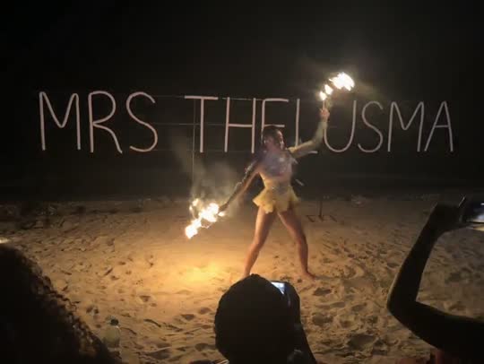 Beachside fire show performance at night in Jamaica