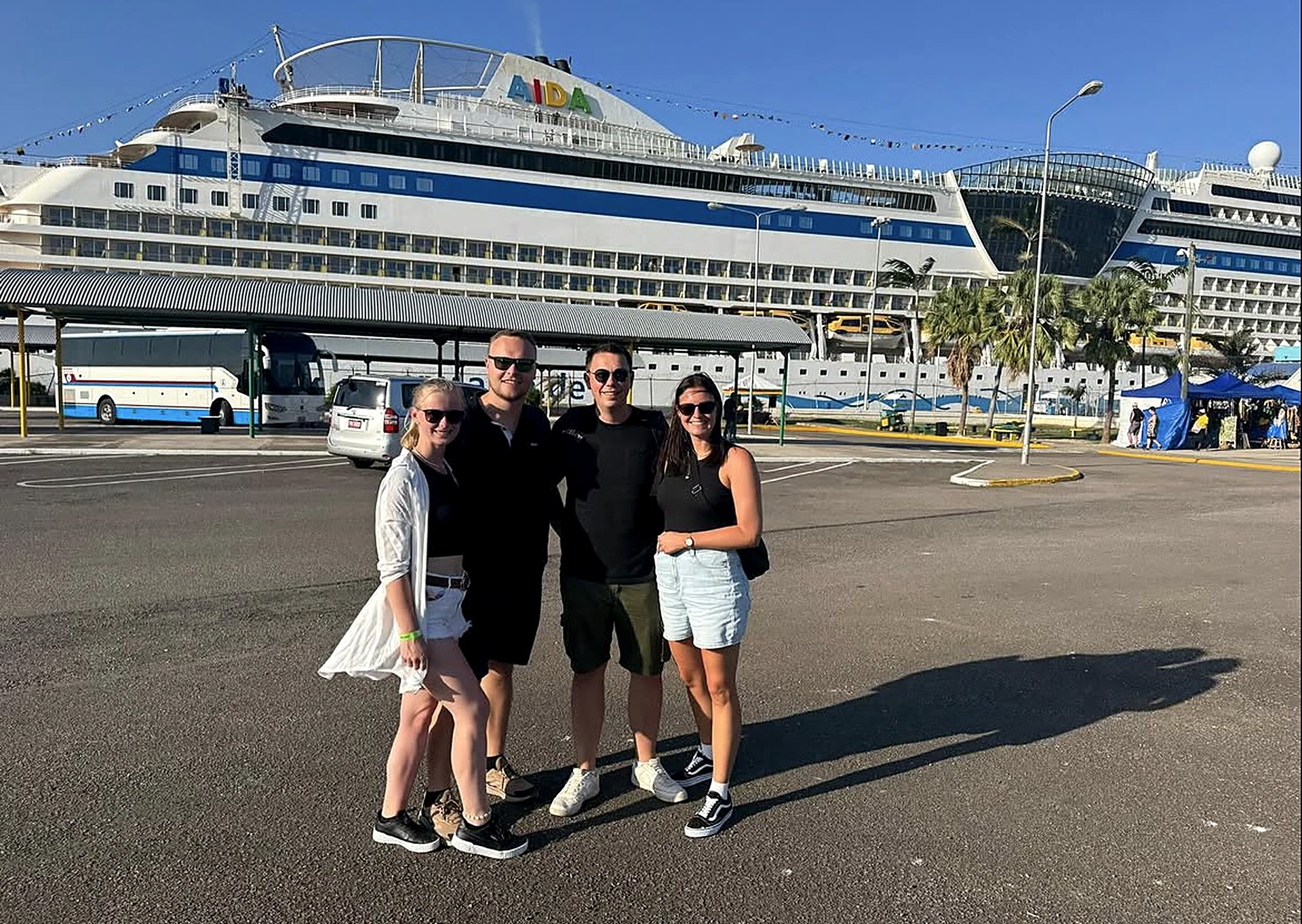 Cruise guests at the Jamaica cruise port with their ship docked behind
